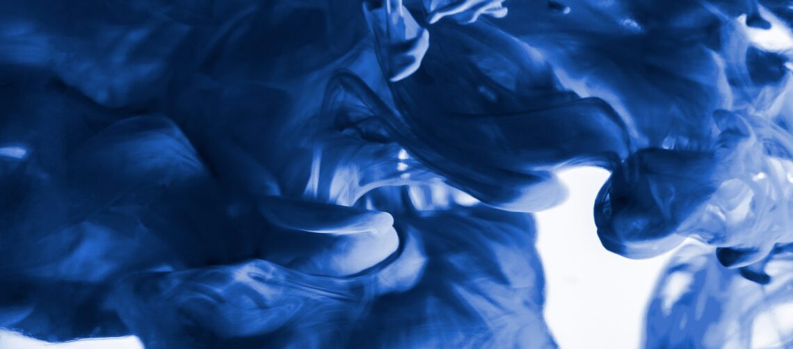 A photo of blue ink moving through water in a billowing pattern.