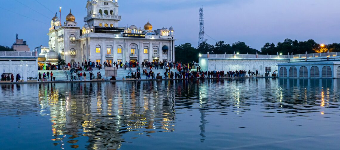 Photo of Gurdwara Bangla Sahib, situated in the heart of Delhi, is a prominent Sikh house of worship. Its serene Sarovar (pond), golden dome, and white marble architecture draw pilgrims and visitors alike. The Langar (community kitchen) serves free meals, reflecting Sikh principles of equality and selfless service.