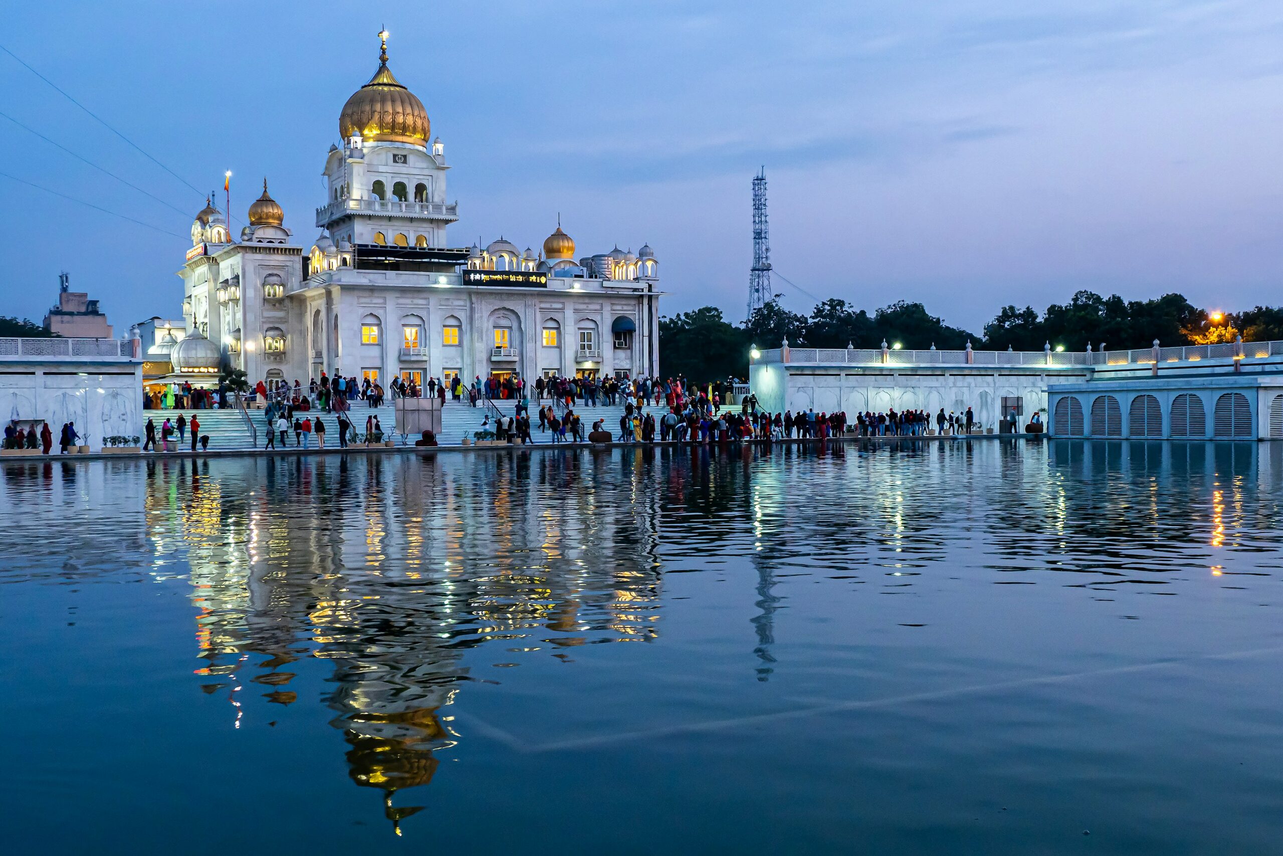 Photo of Gurdwara Bangla Sahib, situated in the heart of Delhi, is a prominent Sikh house of worship. Its serene Sarovar (pond), golden dome, and white marble architecture draw pilgrims and visitors alike. The Langar (community kitchen) serves free meals, reflecting Sikh principles of equality and selfless service.
